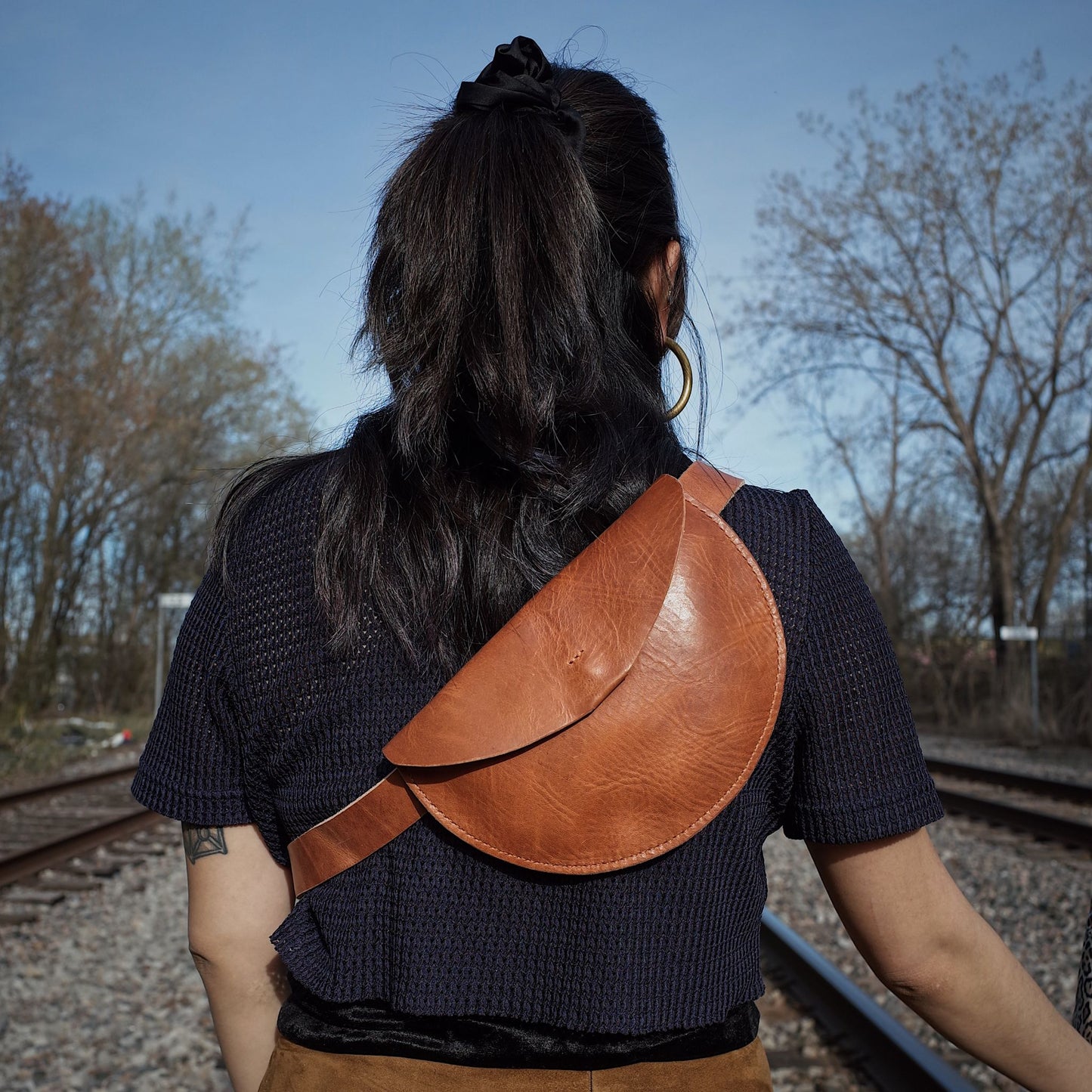 Compact cognac leather moon bag for events and casual outings
