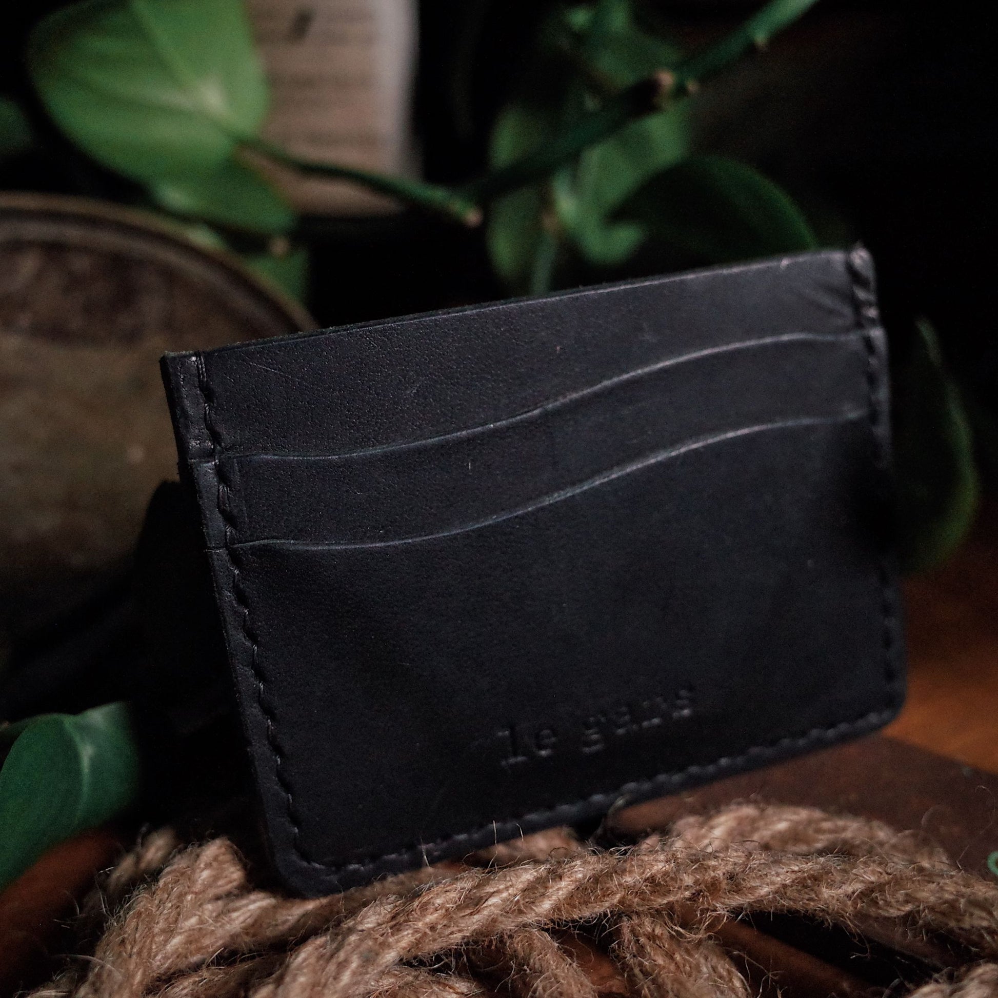 Customizable black leather wallet with premium stitching