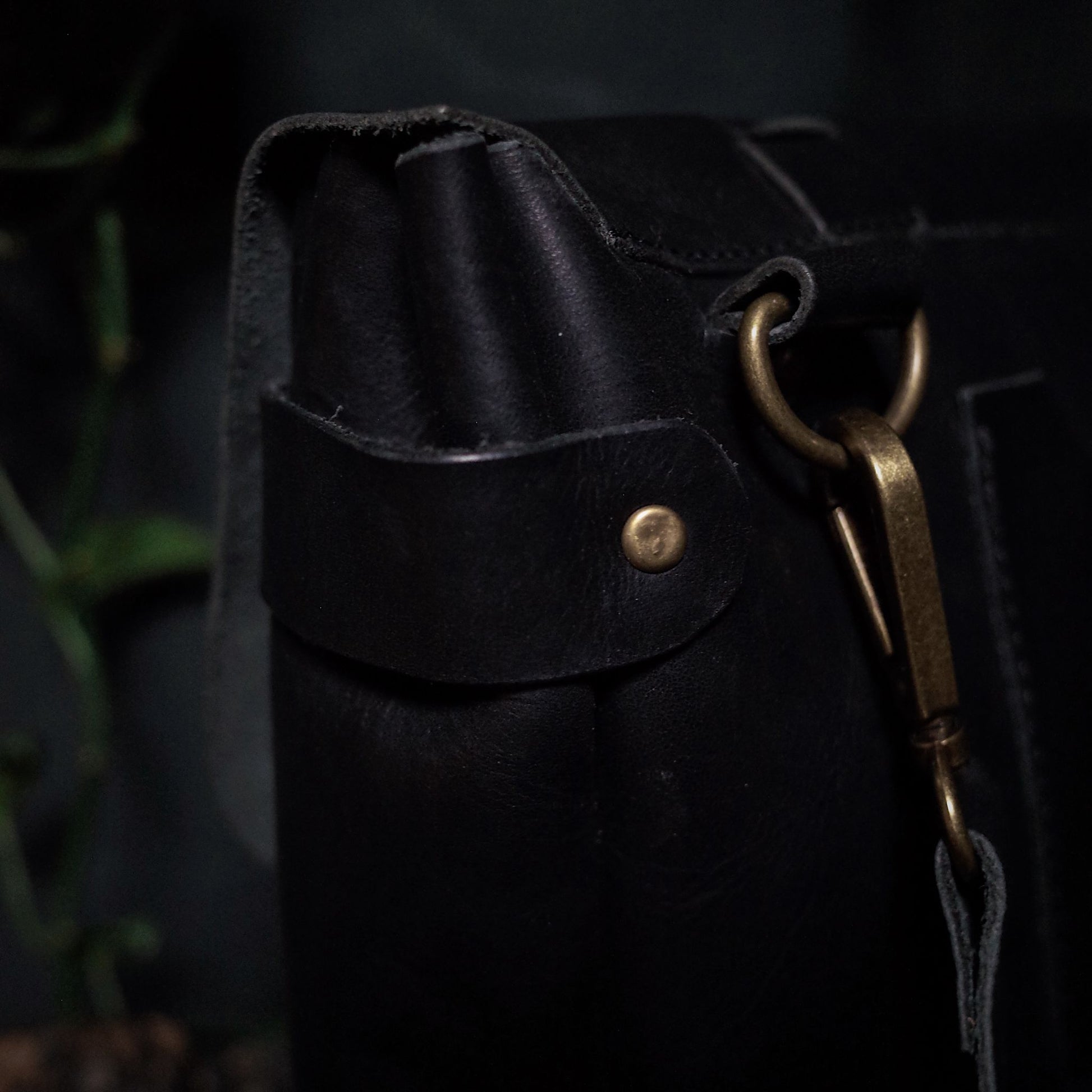 Customizable black leather shoulder bag with premium stitching
