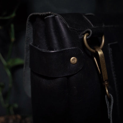 Customizable black leather shoulder bag with premium stitching

