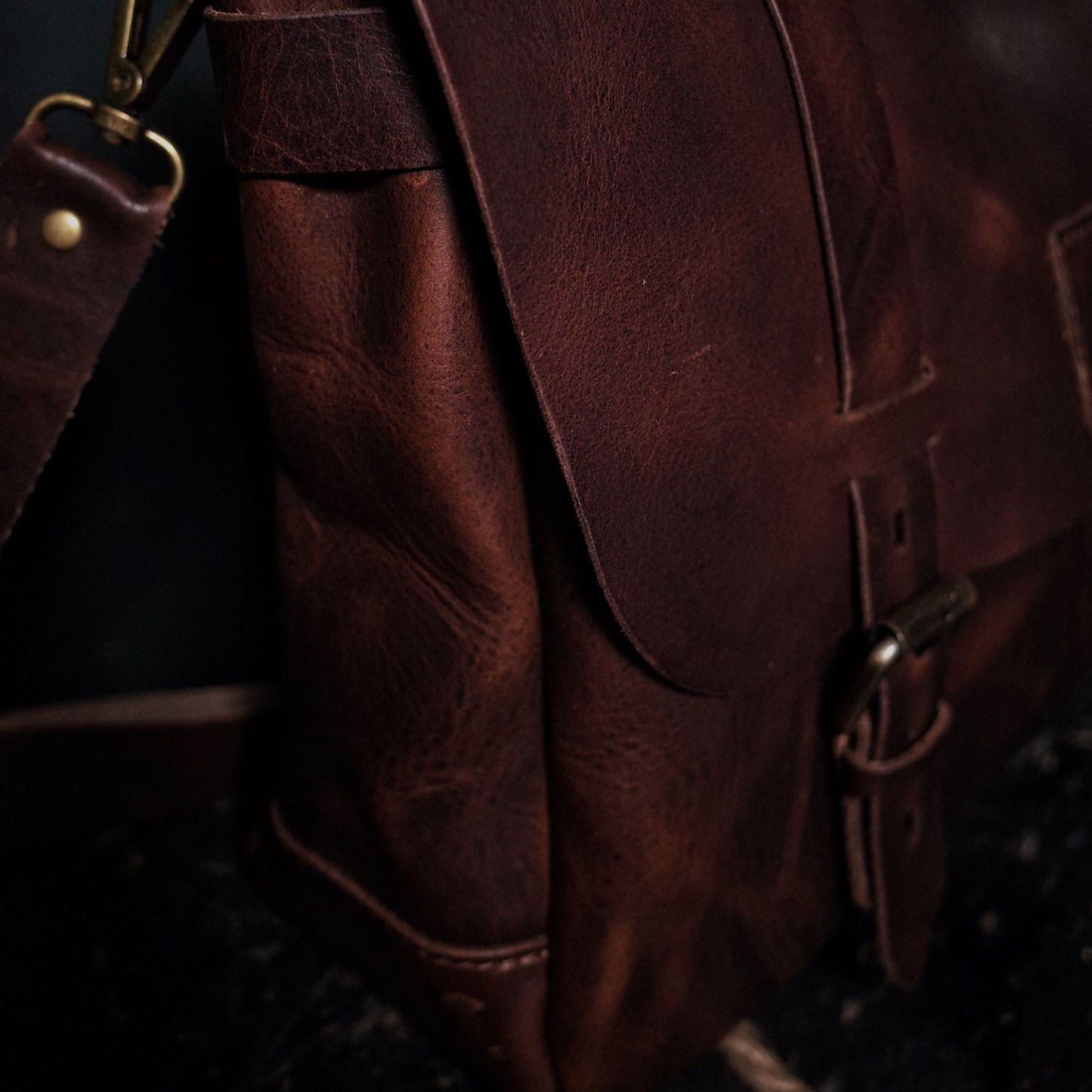 Customizable dark-brown leather messenger bag with premium stitching

