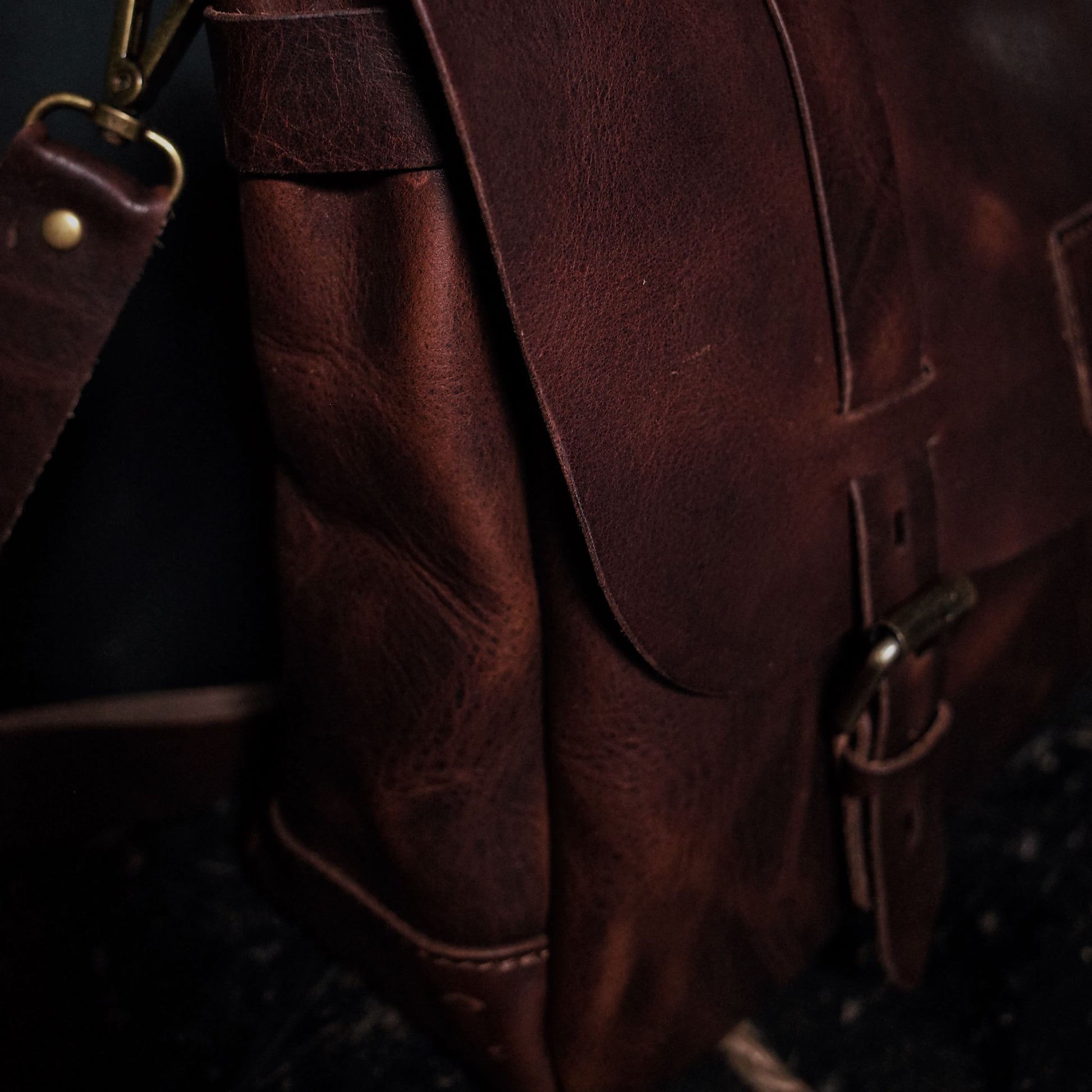 Customizable dark-brown leather messenger bag with premium stitching
