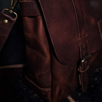 Customizable dark-brown leather messenger bag with premium stitching

