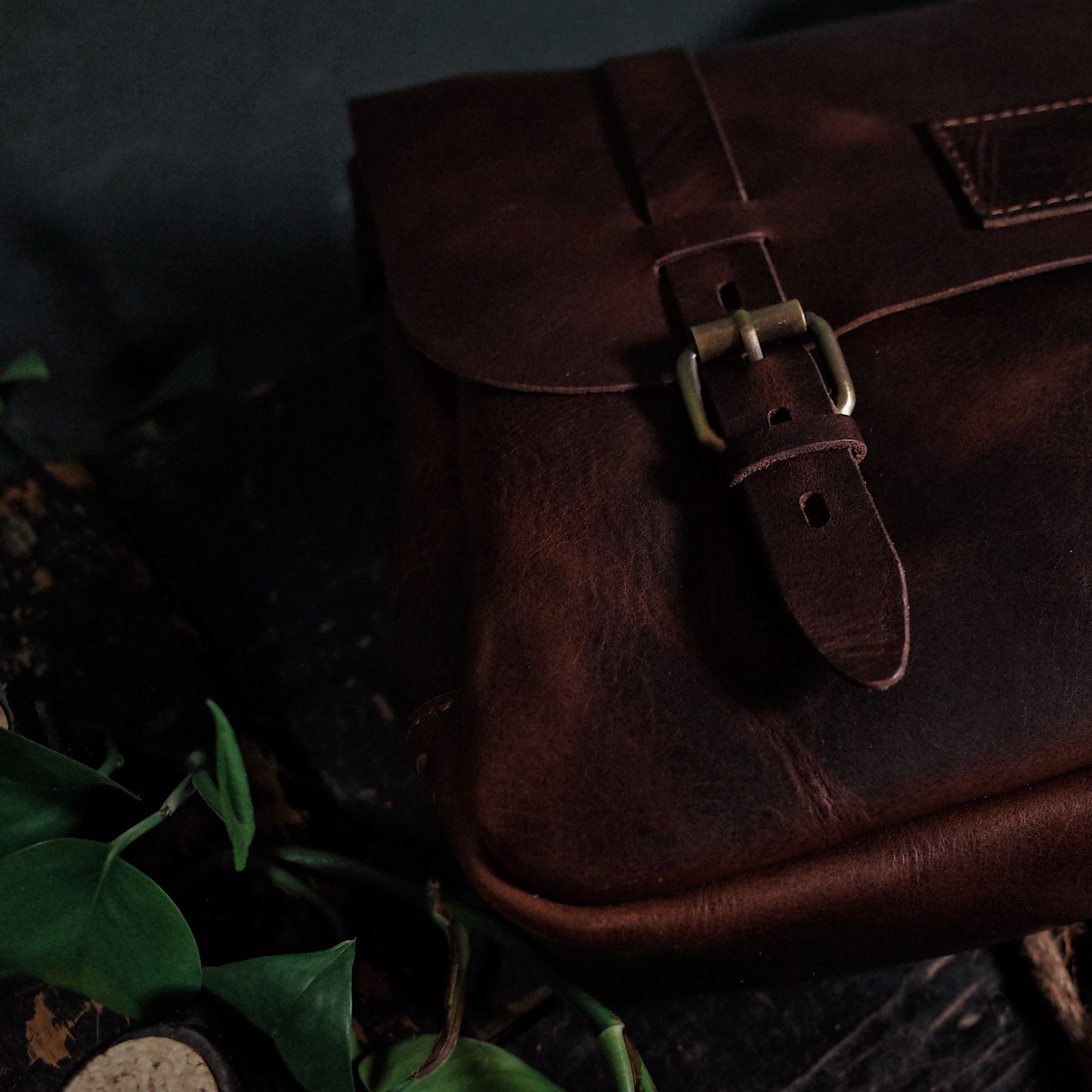 Compact chestnut leather messenger bag ideal for laptops and documents
