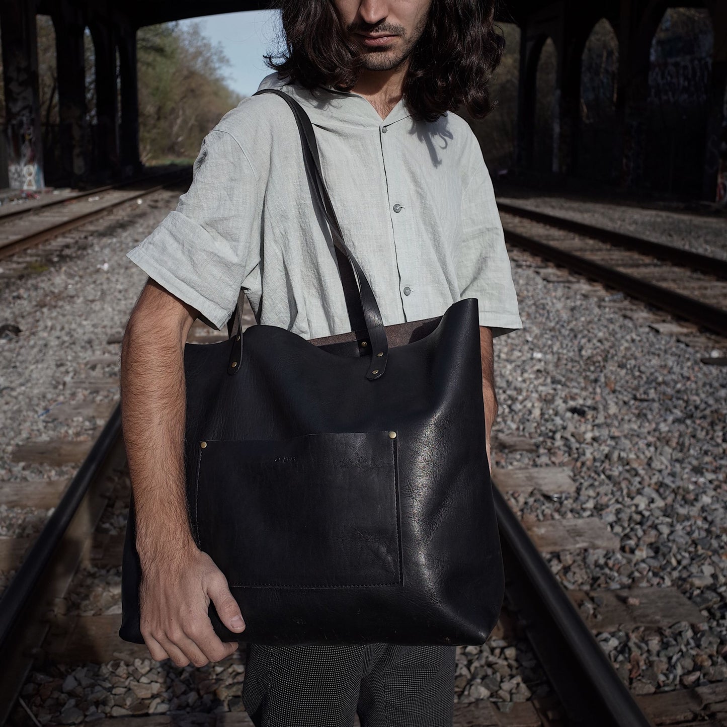 Sleek black leather satchel for commuting and travel
