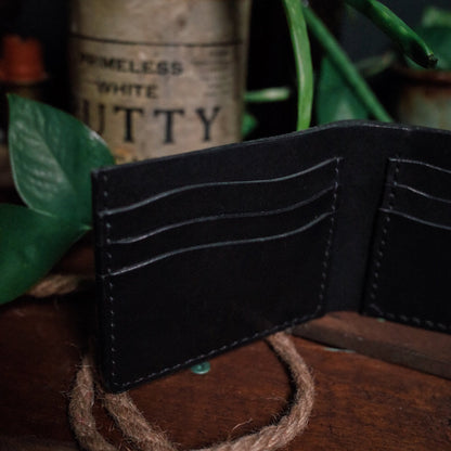 Minimalist black leather bifold wallet with elegant craftsmanship
