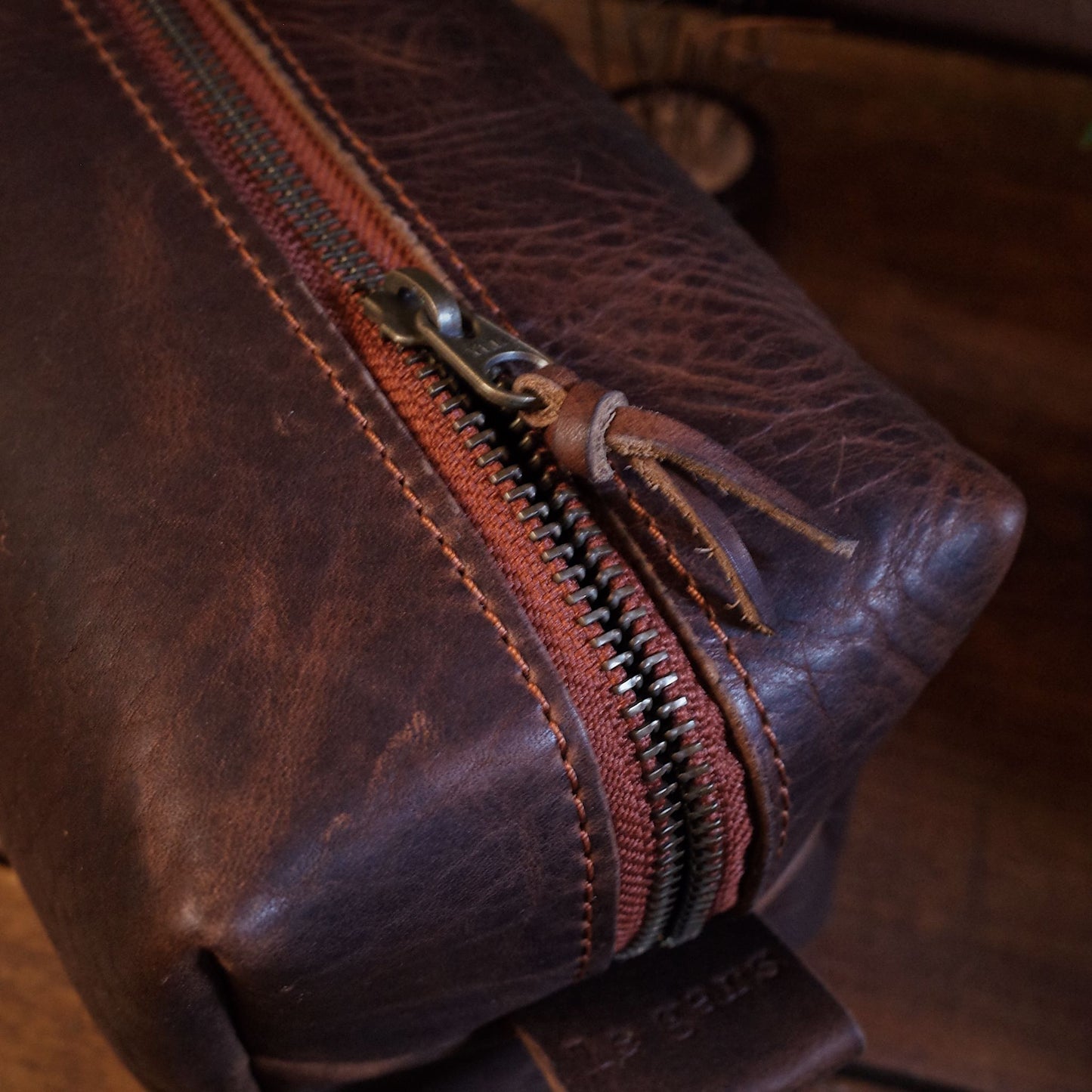 Full-grain dark-brown leather wash bag with spacious compartments
