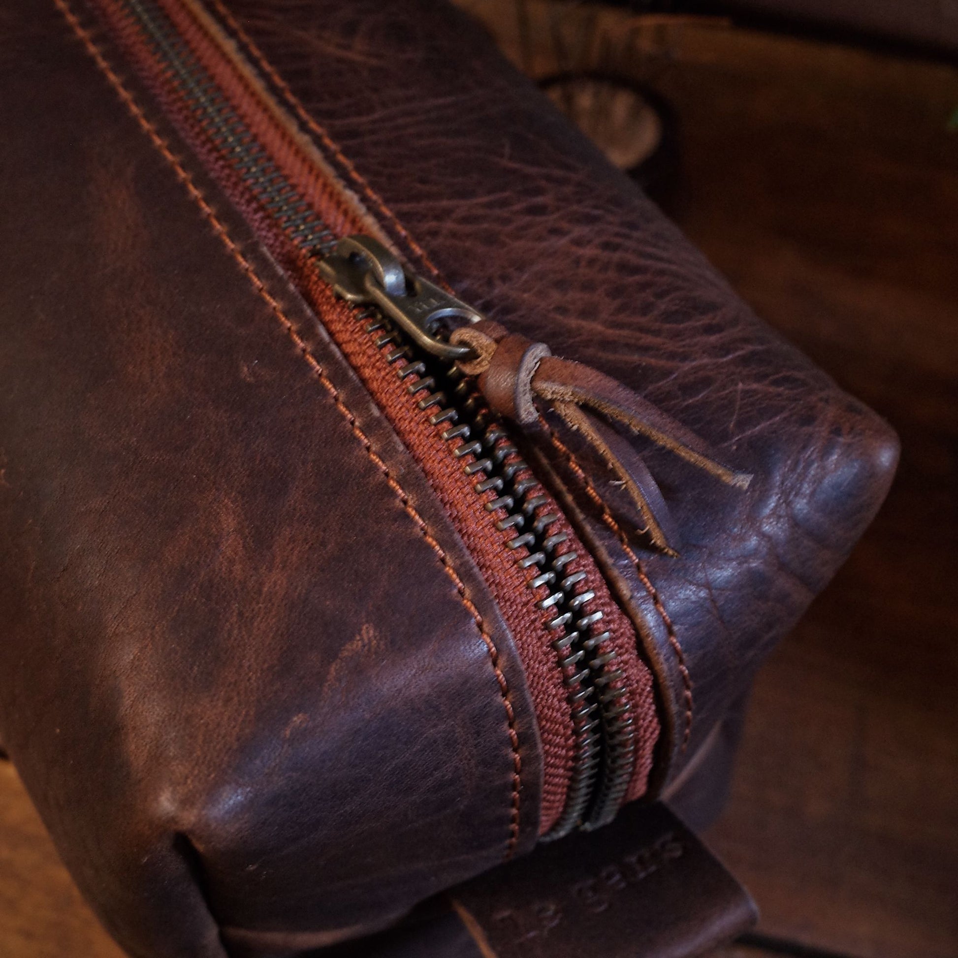 Full-grain dark-brown leather wash bag with spacious compartments
