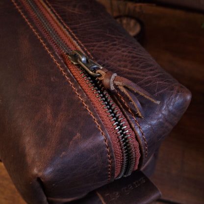 Full-grain dark-brown leather wash bag with spacious compartments
