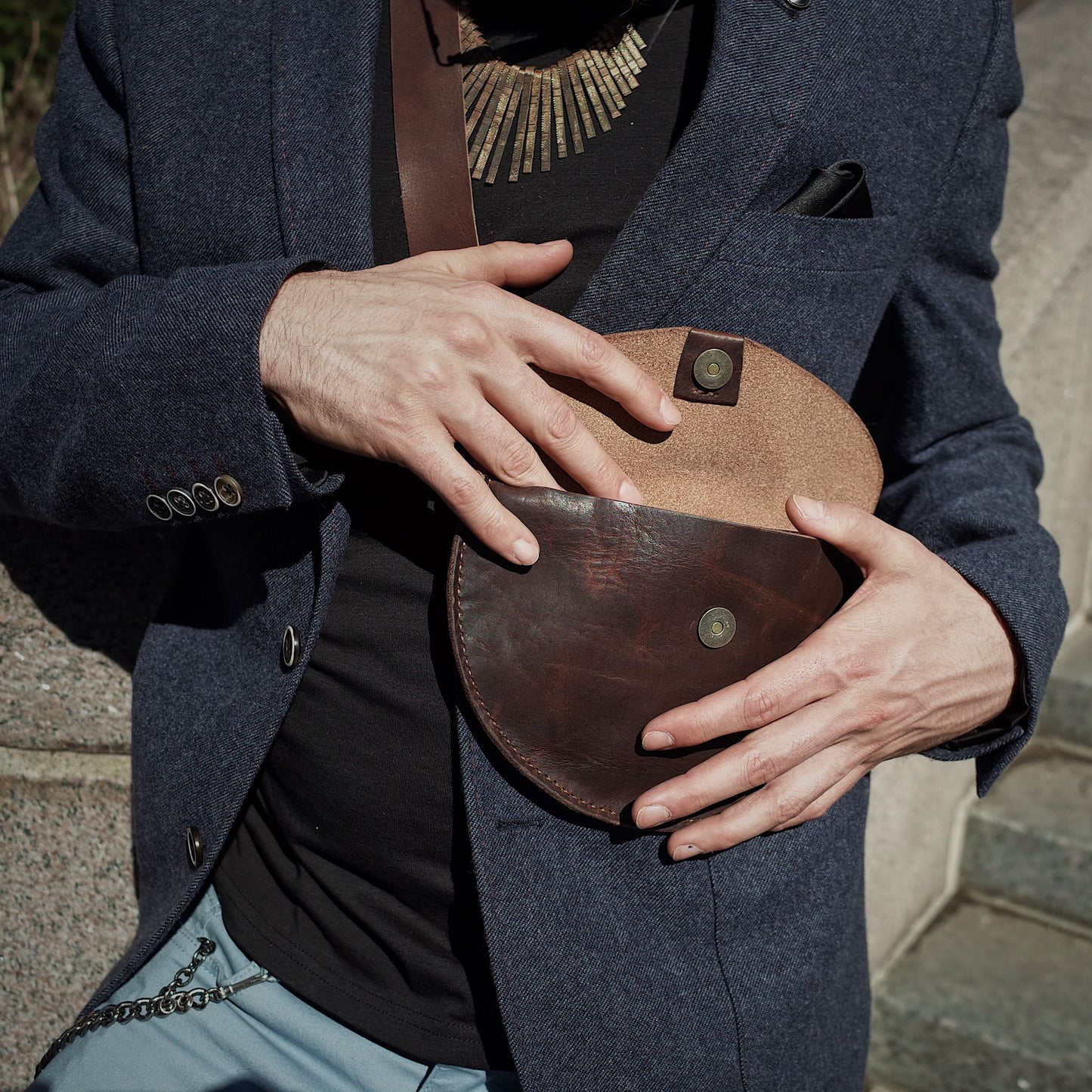 Artisanal dark-brown leather moon bag with minimalist appeal
