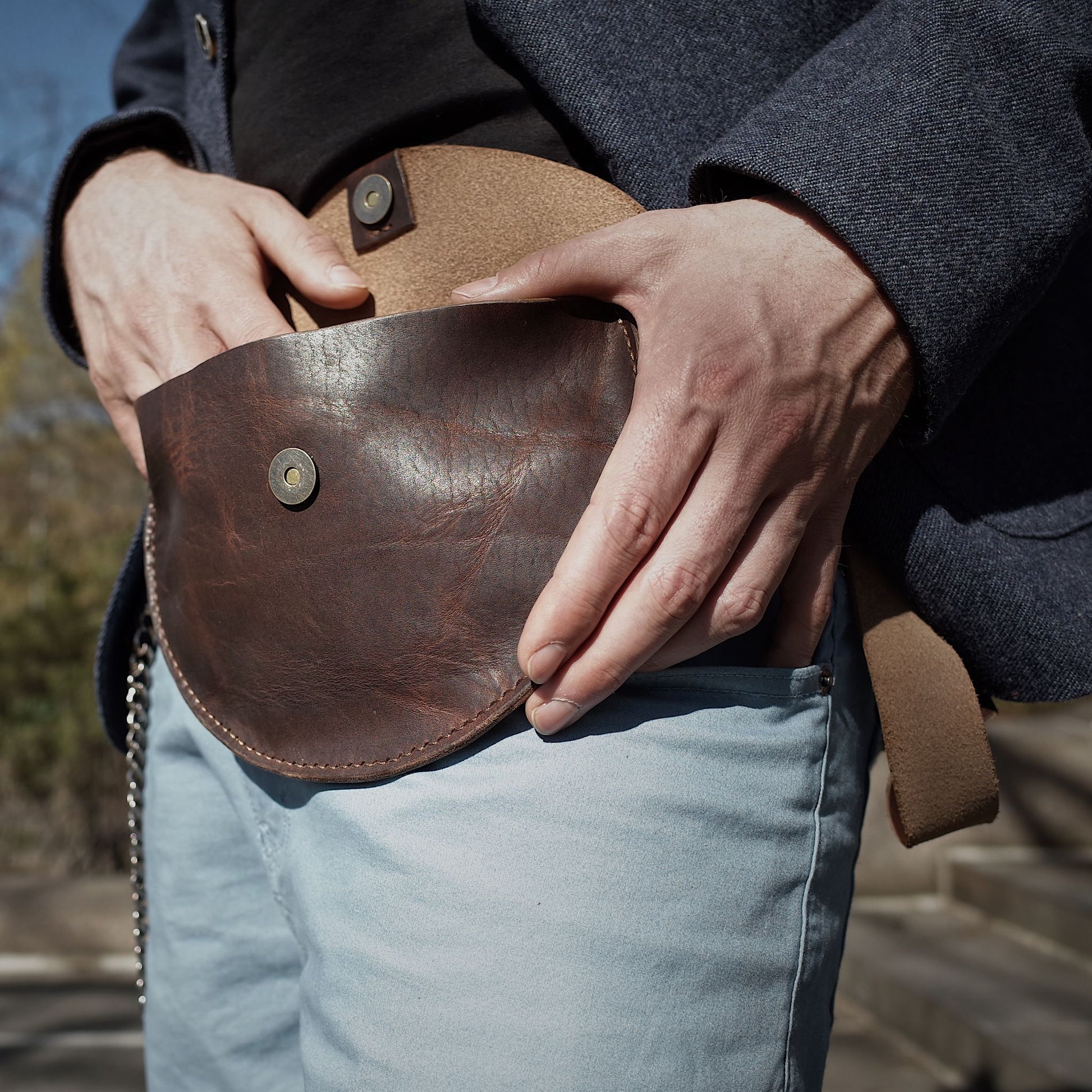 Sleek dark-brown leather belt bag for carrying essentials
