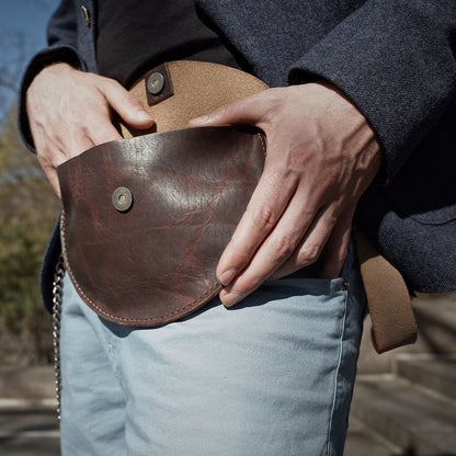 Sleek dark-brown leather belt bag for carrying essentials
