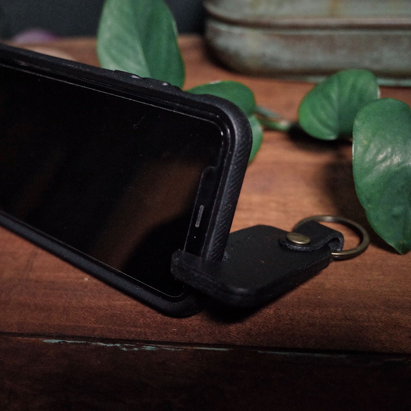 Sleek black leather keychain with phone holder, made in Montreal

