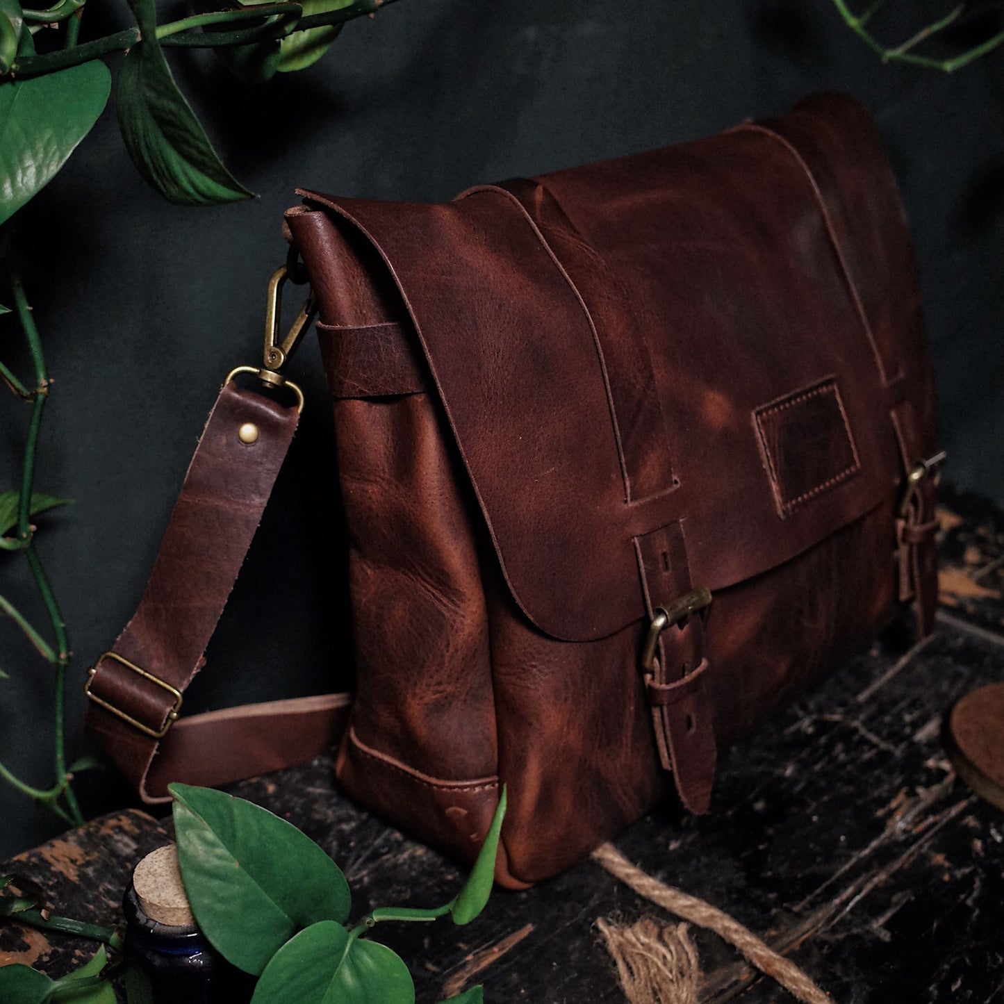Spacious dark-brown leather messenger bag with adjustable shoulder strap
