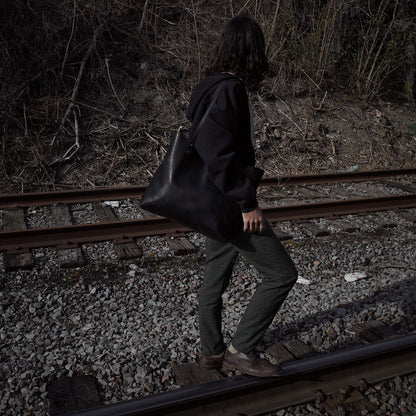 Spacious black leather satchel designed for professionals
