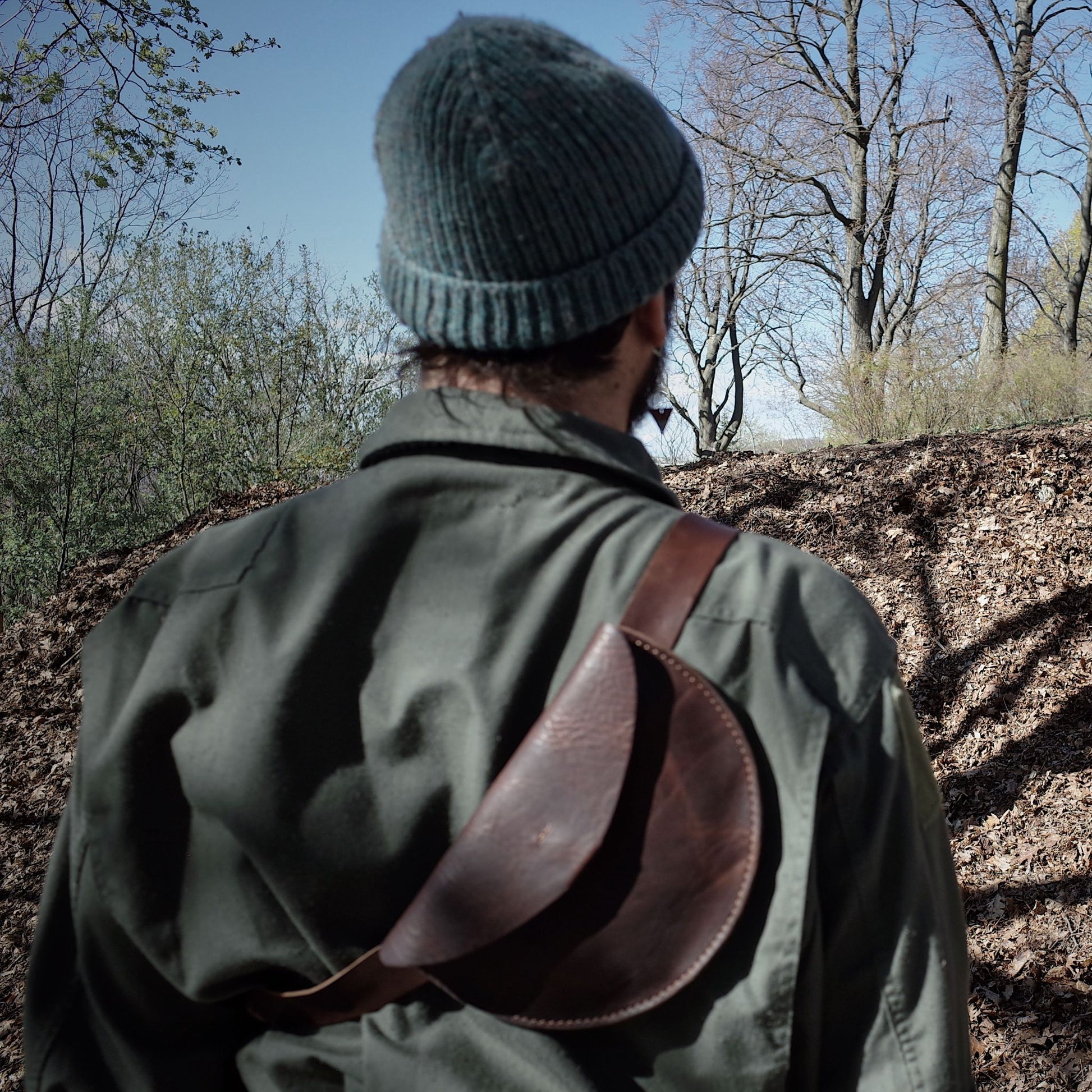Sleek chestnut leather moon bag for urban exploration
