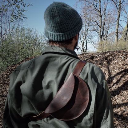 Sleek chestnut leather moon bag for urban exploration
