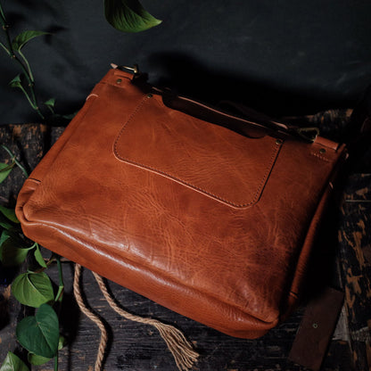 Premium saddle tan leather bag with padded laptop compartment
