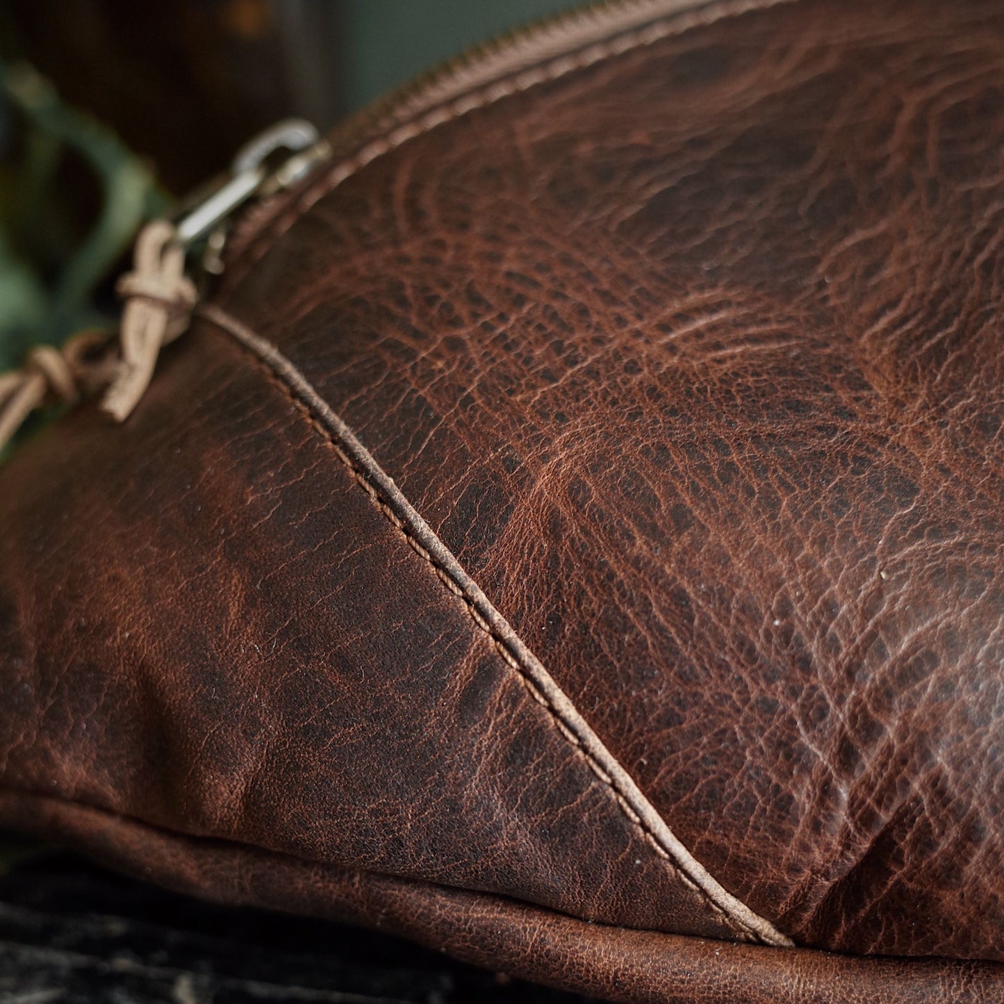 Large chocolate leather moon bag with spacious compartments
