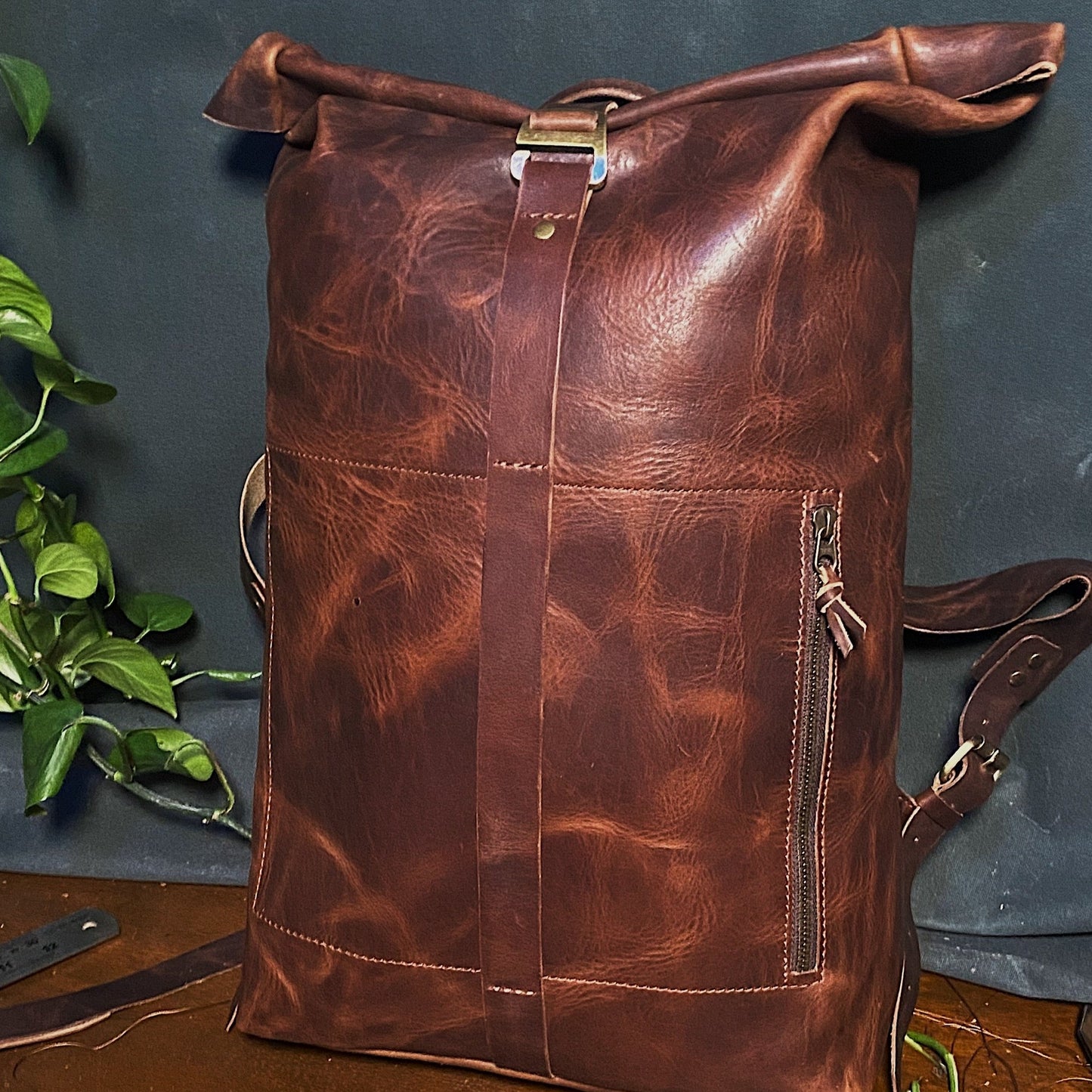 Minimalist chocolate leather roll-top knapsack with secure delivery buckle
