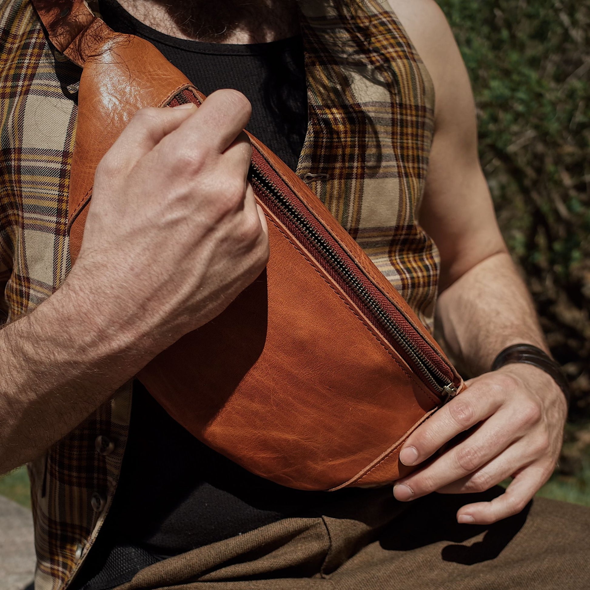 Premium caramel leather fanny pack with oversized interior compartments
