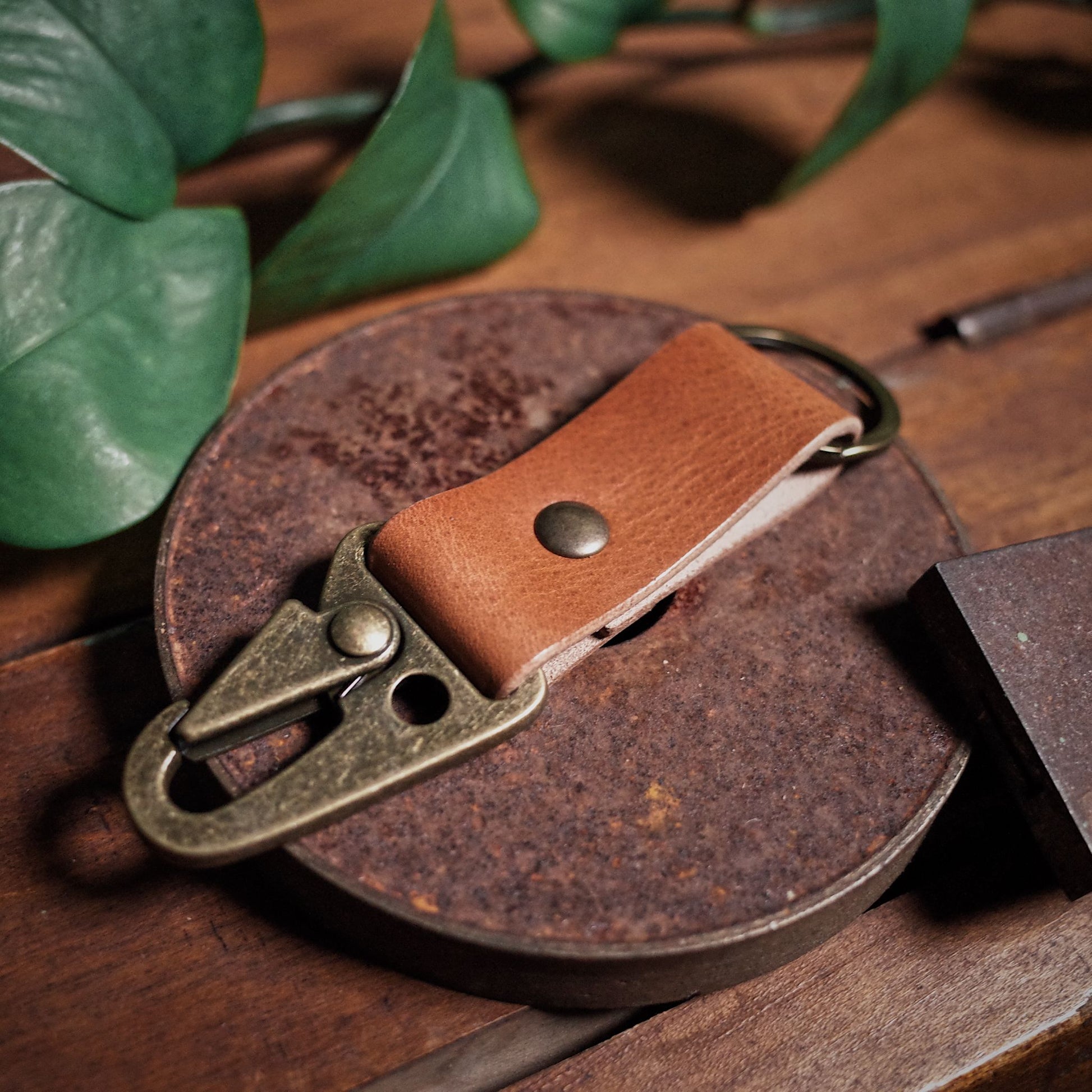 Durable English tan leather carabiner key holder inspired by military style
