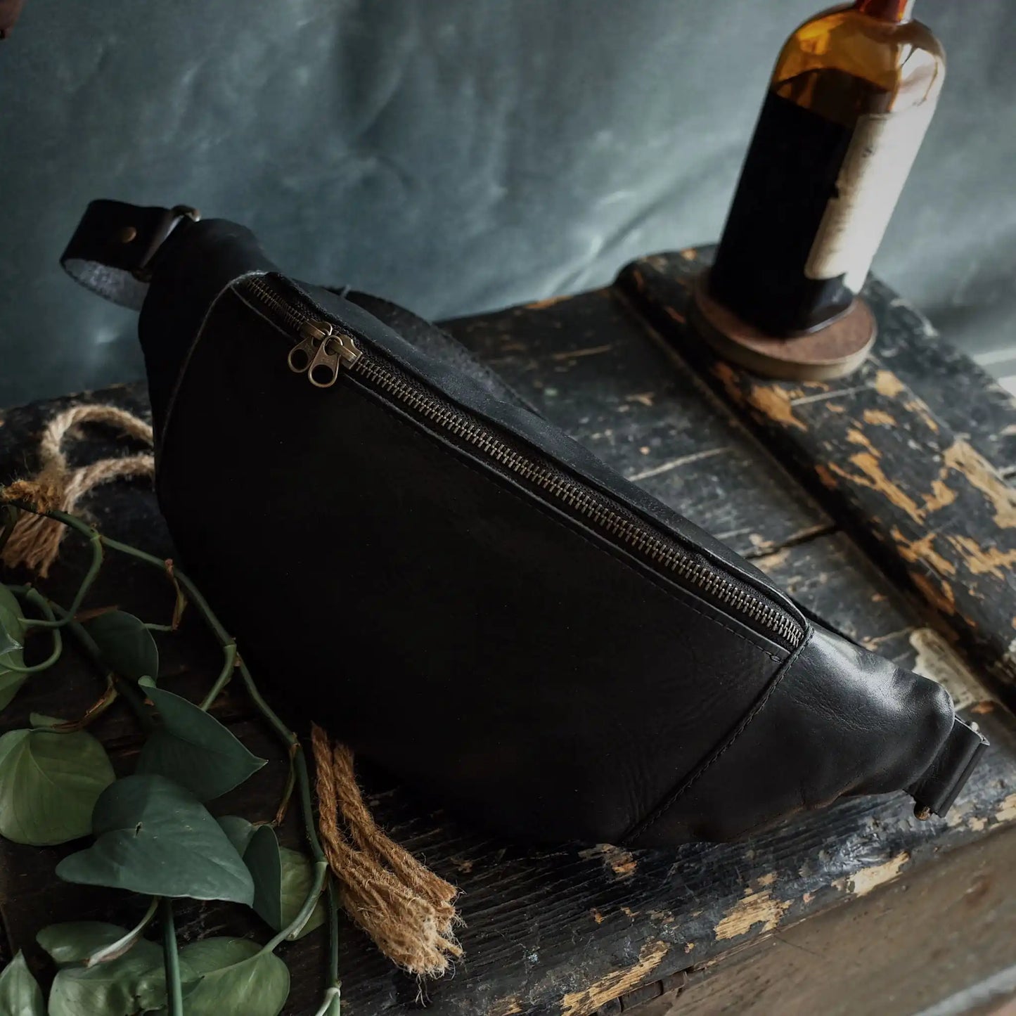 Large black leather belt bag designed for ample storage
