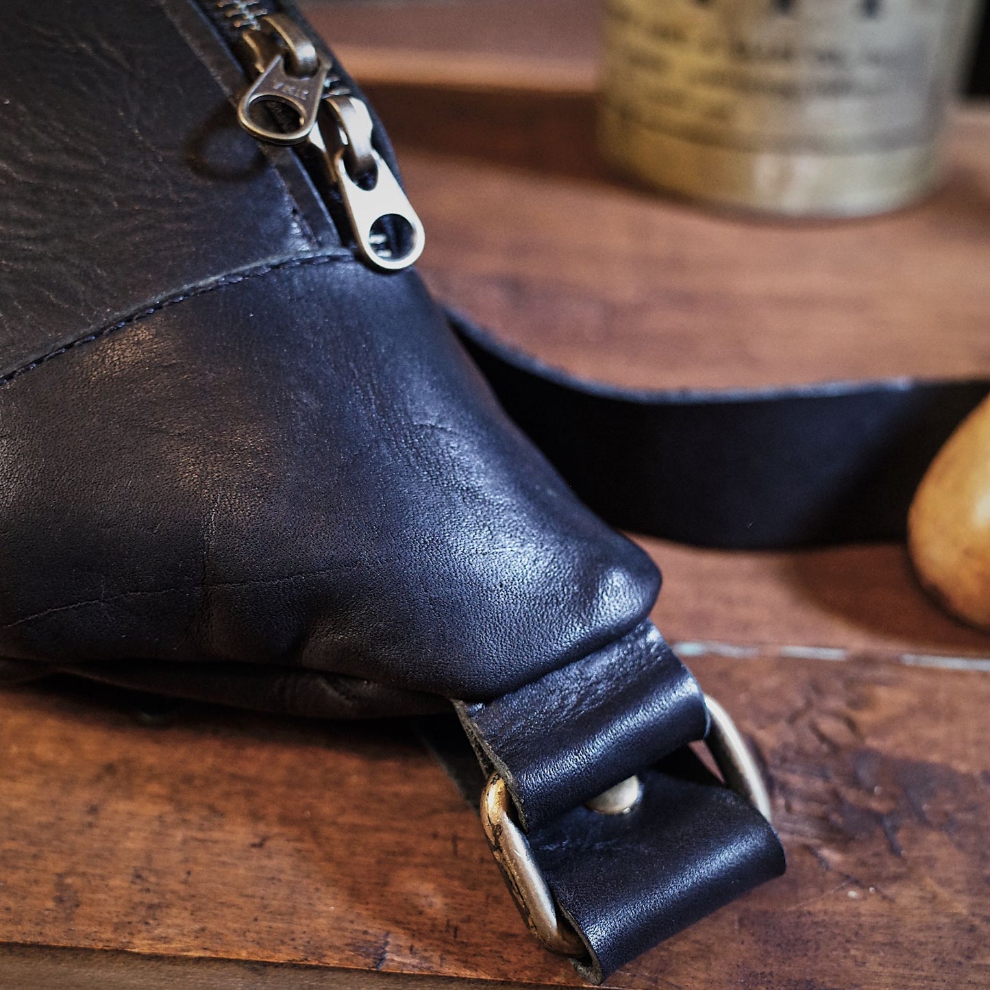 Spacious black leather moon bag for oversized essentials
