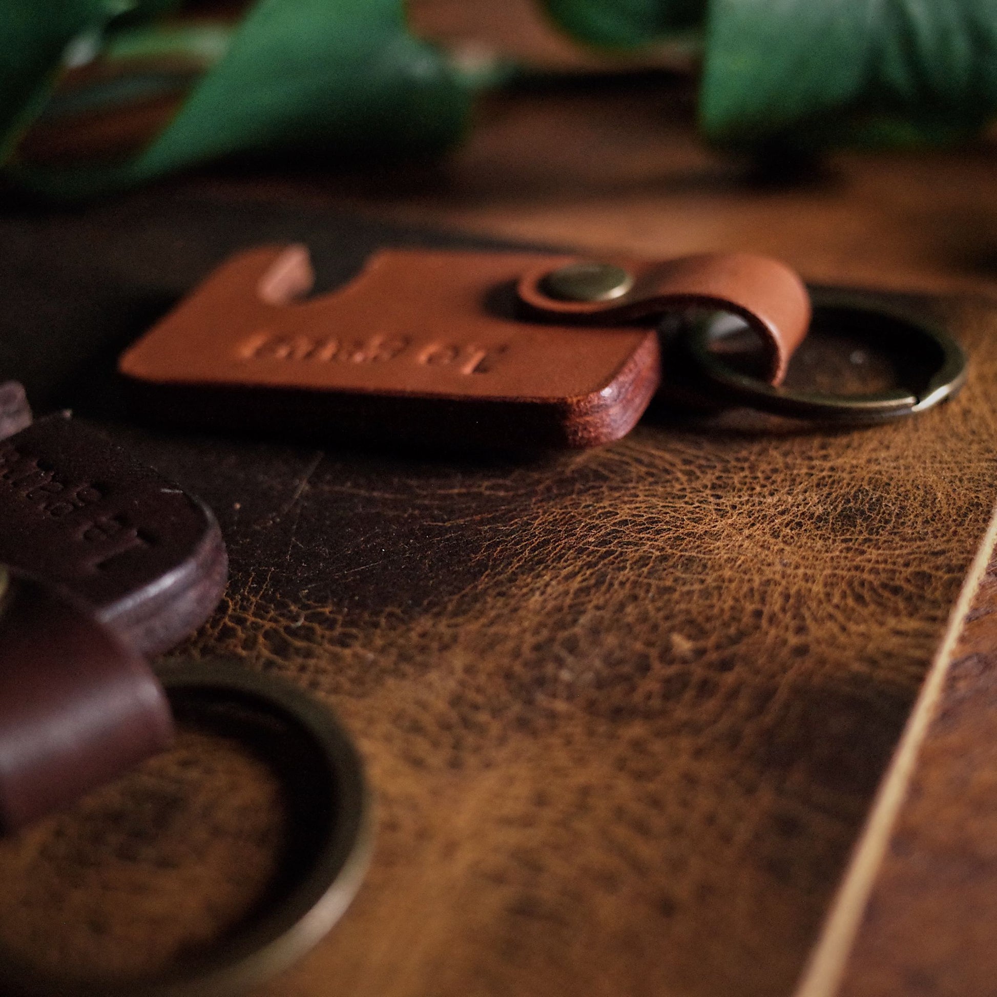 Customizable light brown leather keychain with built-in phone holder
