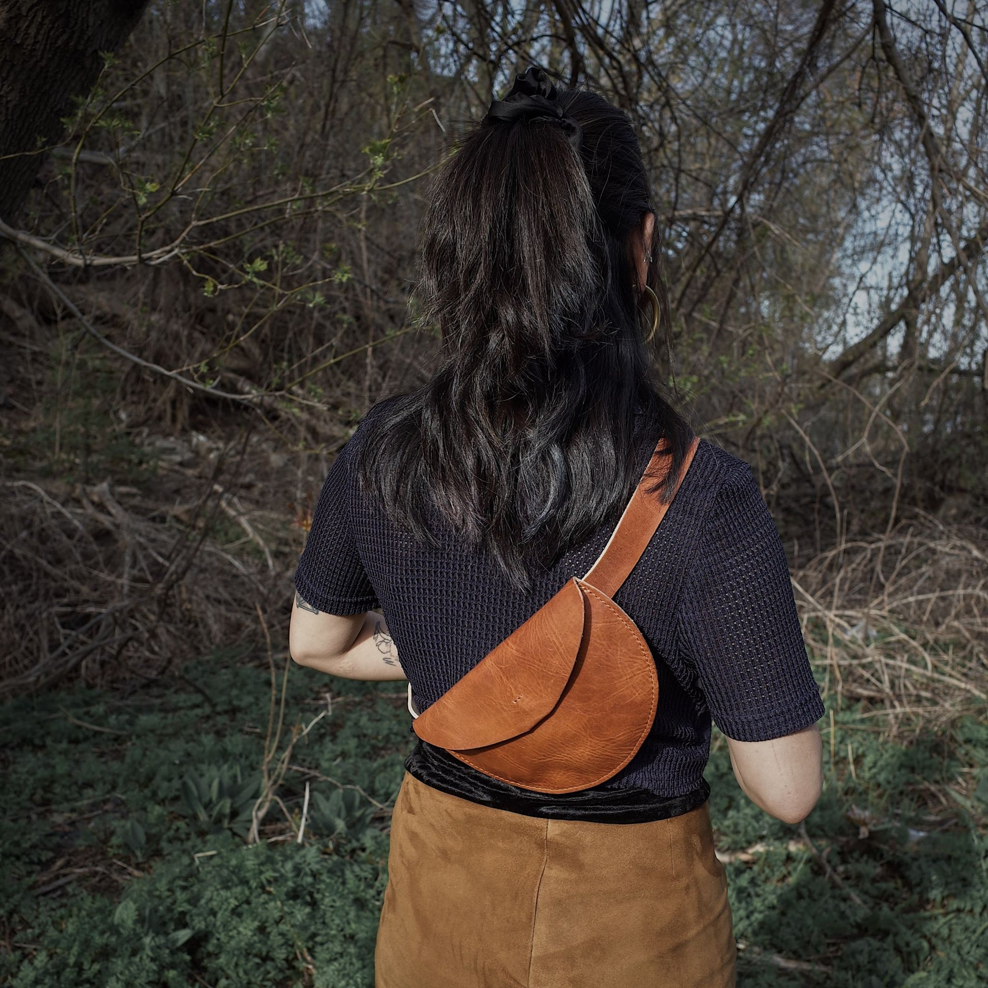 Sleek light brown leather belt bag for parties and travel
