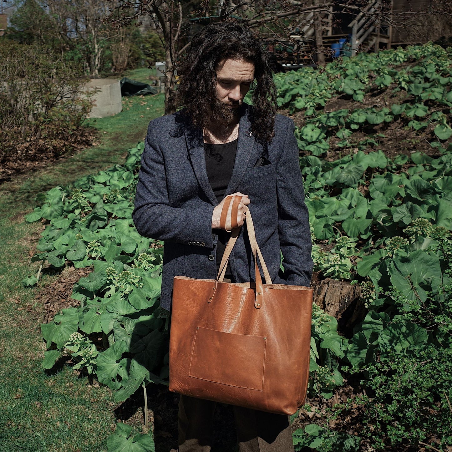 Light brown leather satchel with spacious compartments for travel essentials
