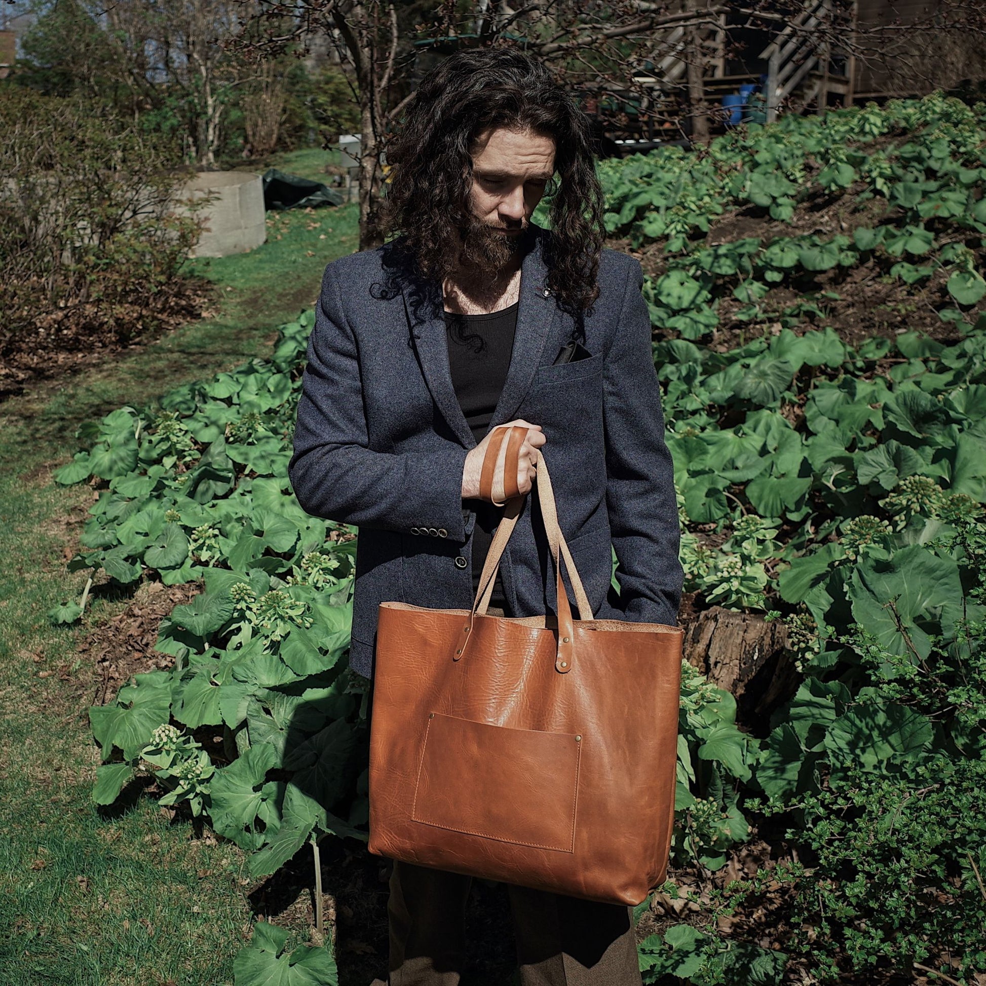 Light brown leather satchel with spacious compartments for travel essentials
