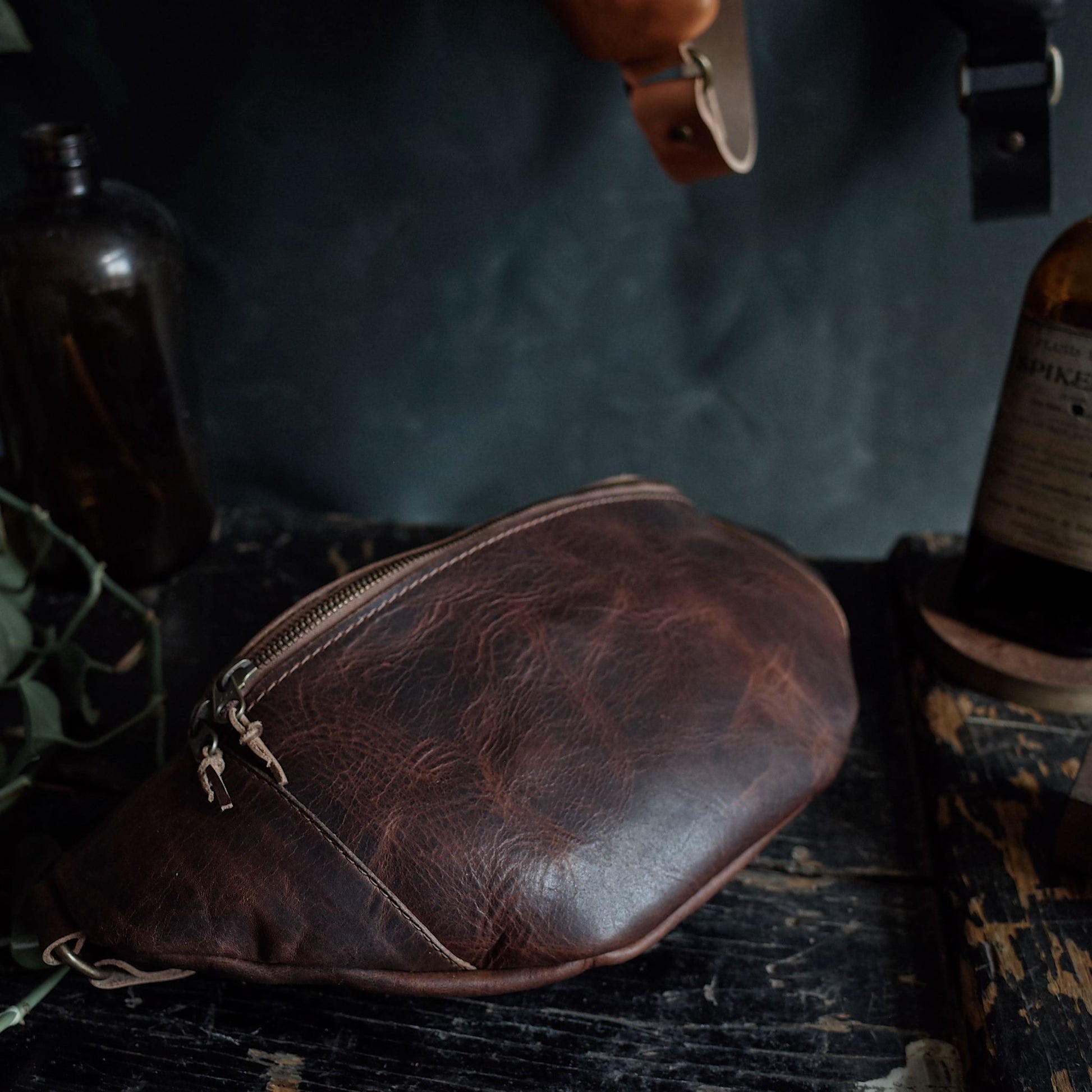 Large chestnut leather belt bag with secure zipper for extra storage
