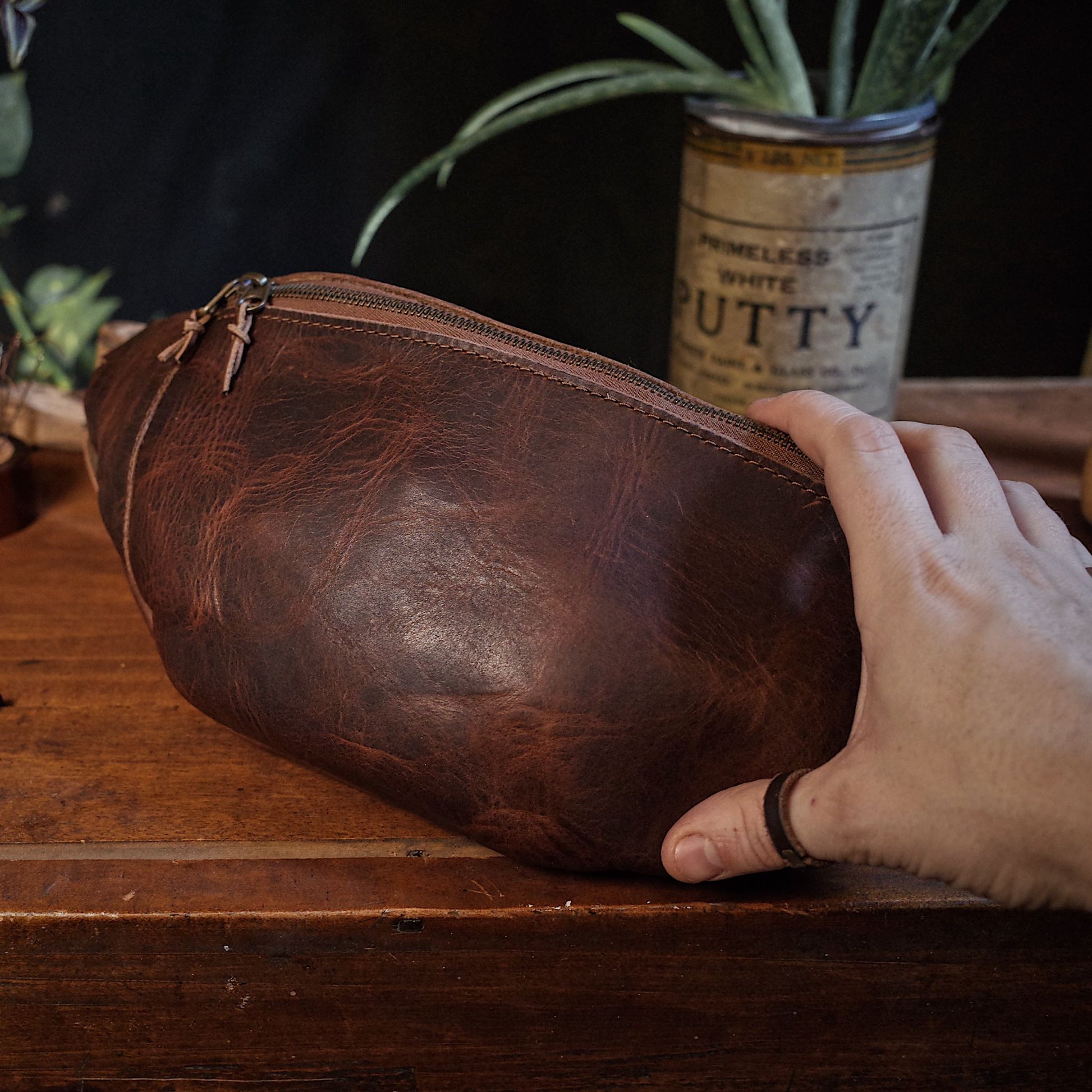 Durable coffee brown leather fanny pack with functional zipper
