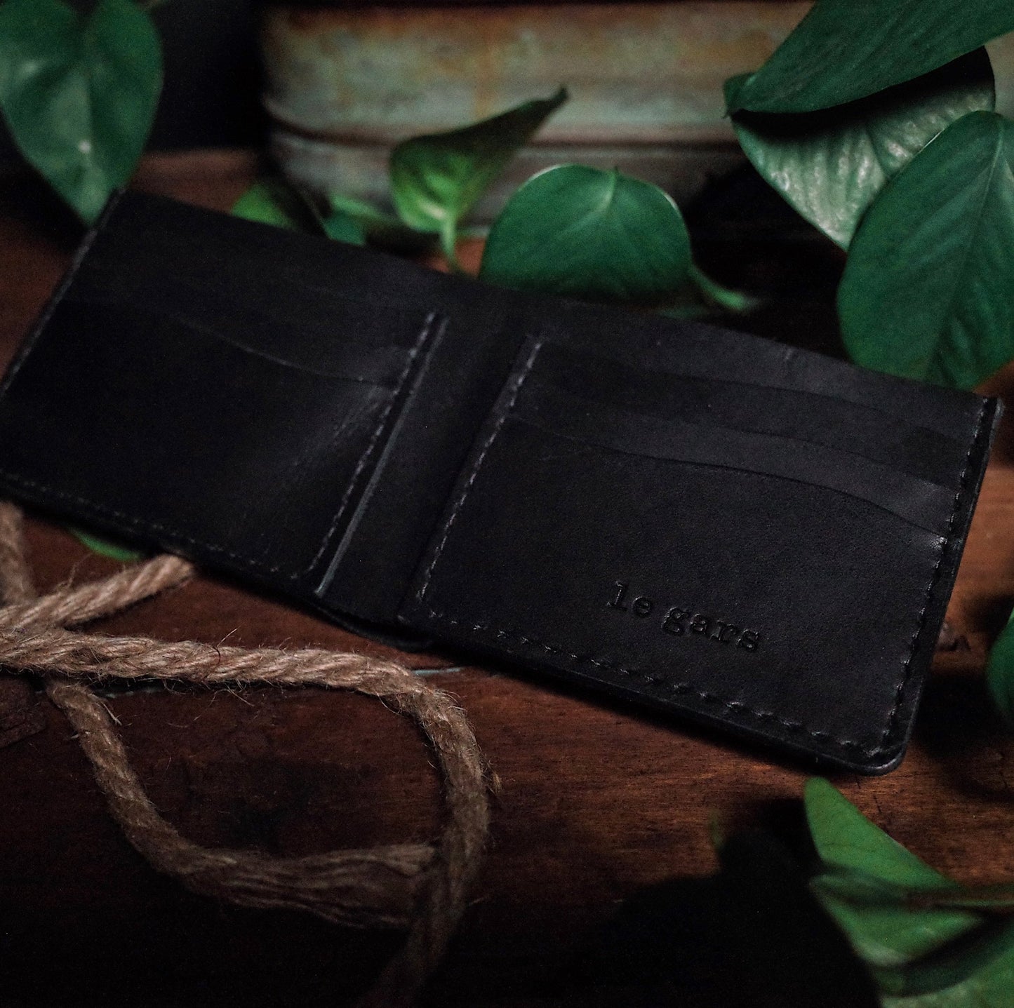 Stylish black leather bifold wallet with durable brass snaps
