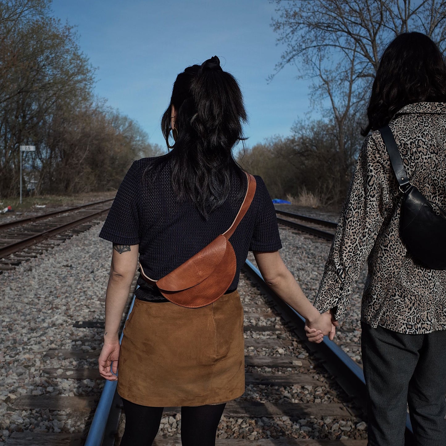 Sleek caramel leather moon bag for carrying essentials at events
