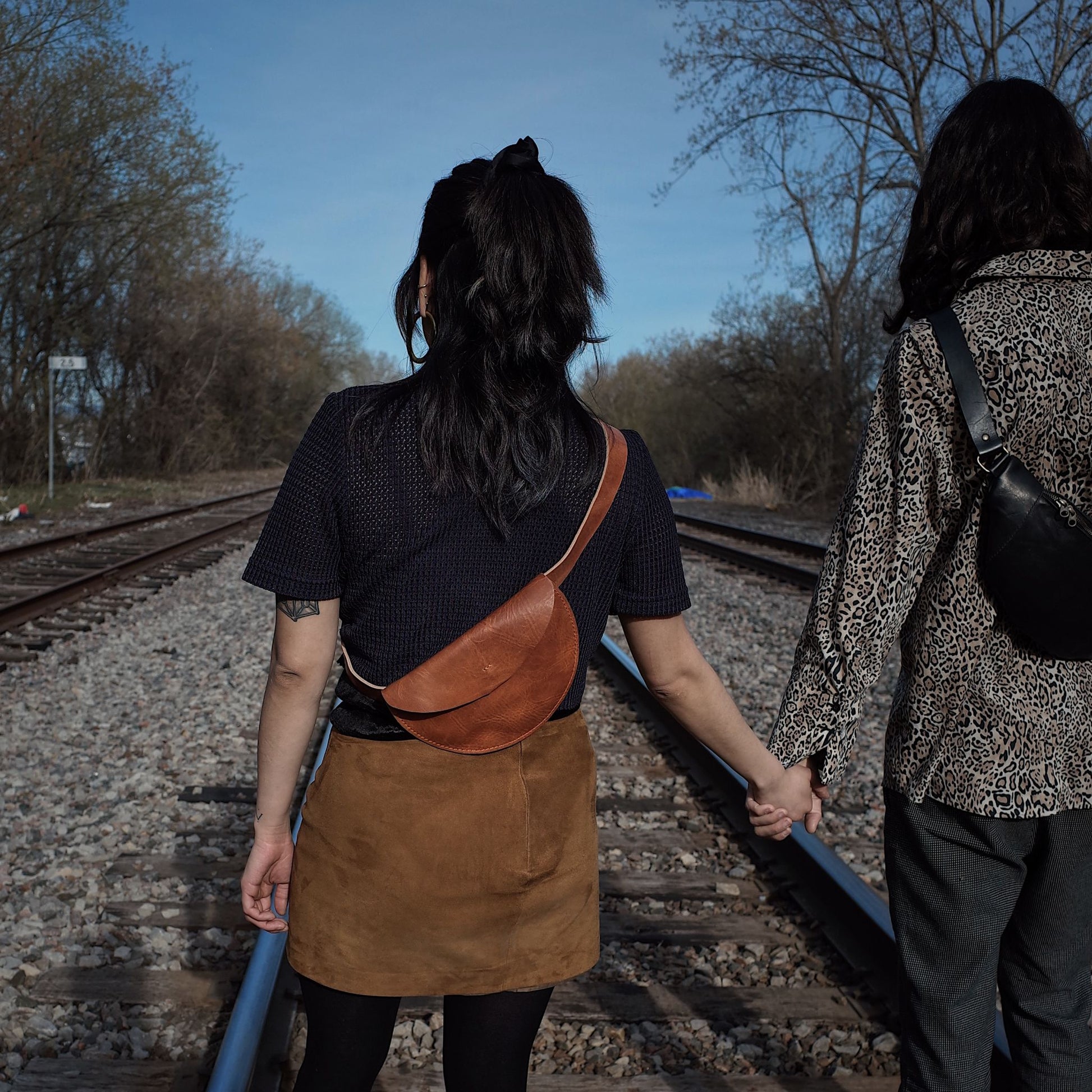Sleek caramel leather moon bag for carrying essentials at events
