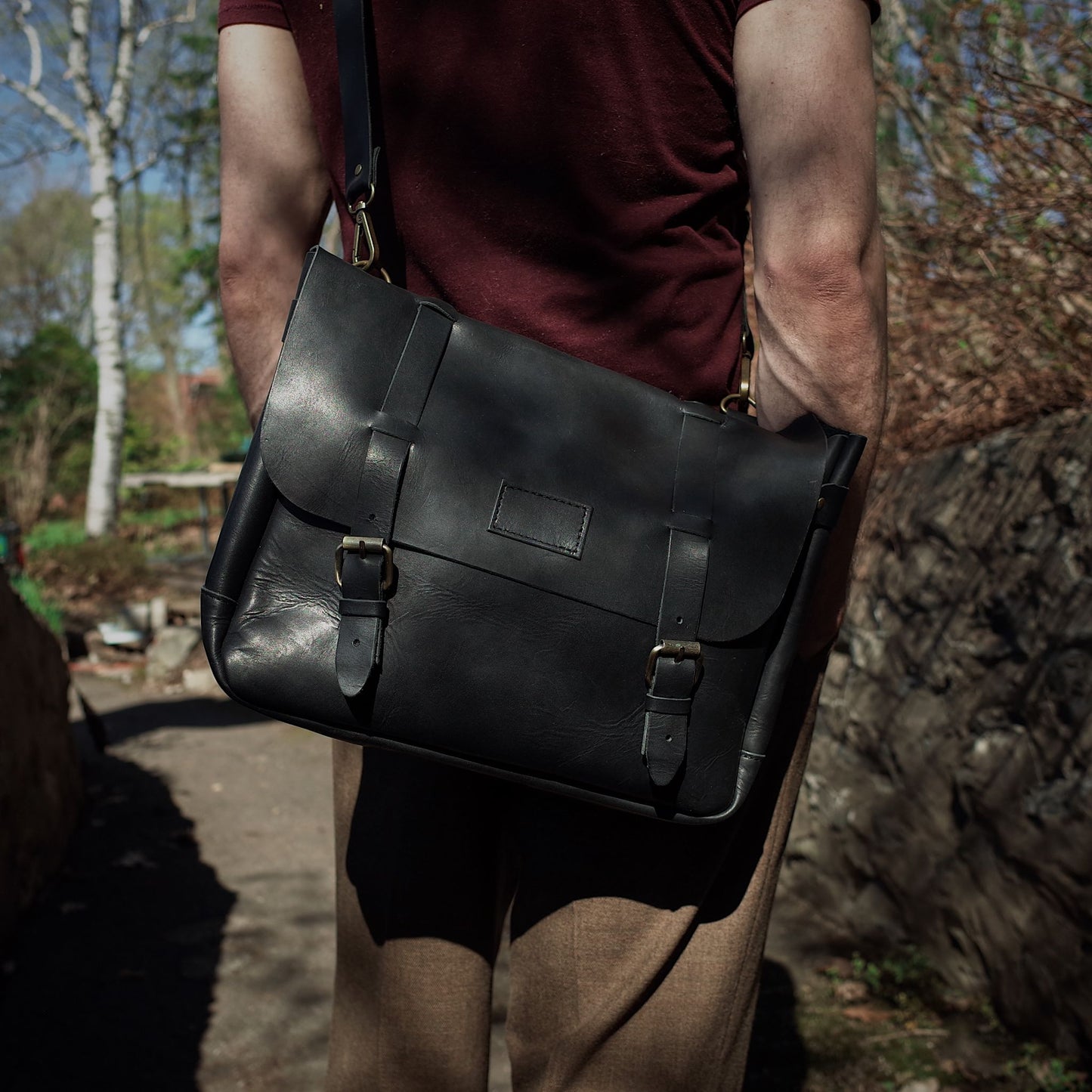Handmade black leather carryall with minimalist appeal
