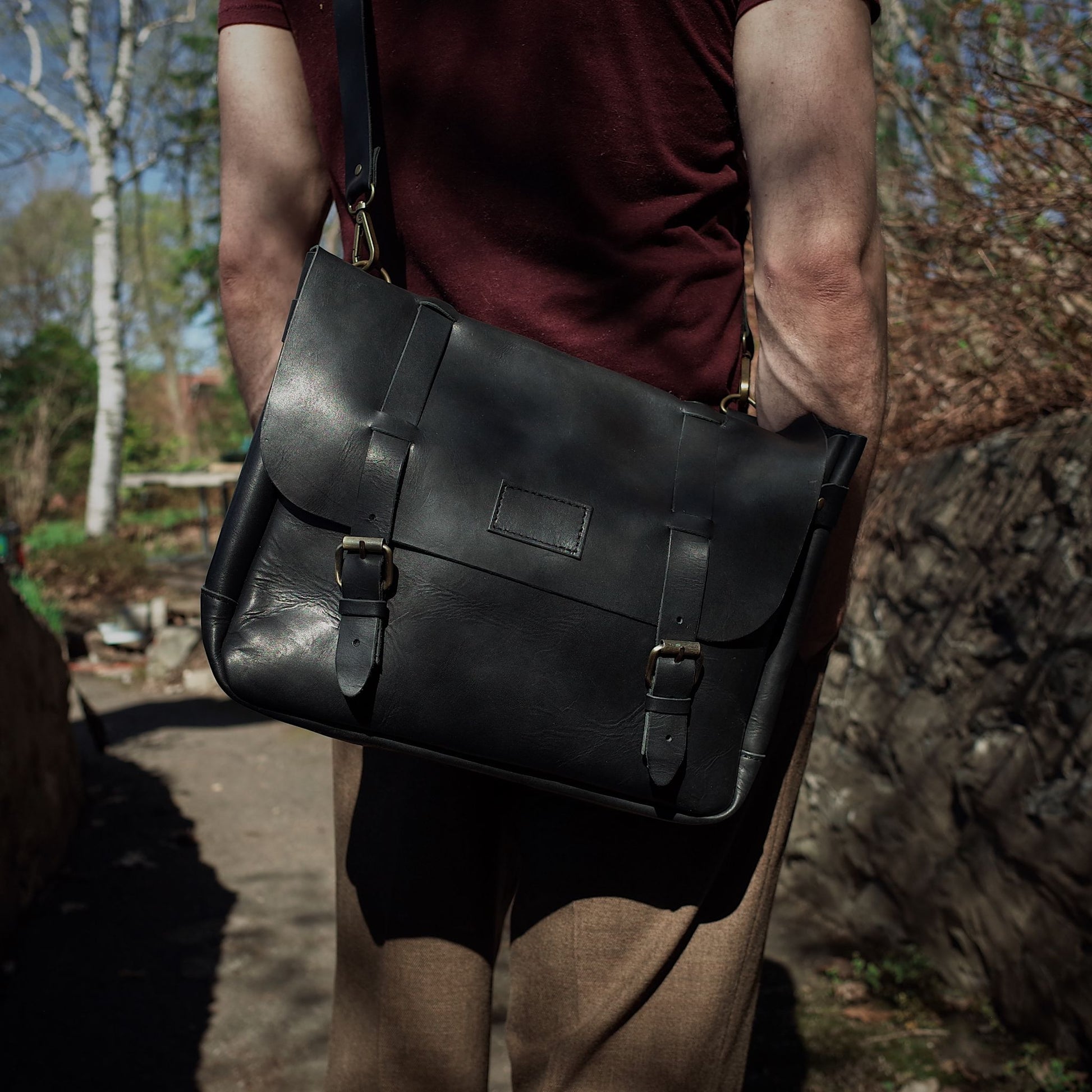Handmade black leather carryall with minimalist appeal

