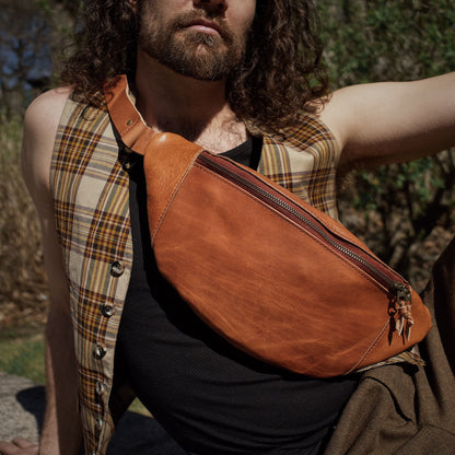 Durable honey brown leather moon bag with extra storage space
