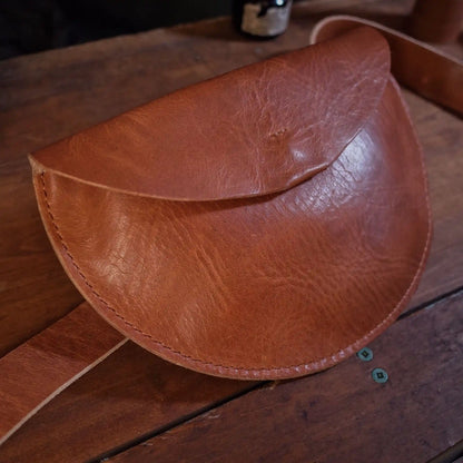 Minimalist caramel leather moon bag for parties and casual outings
