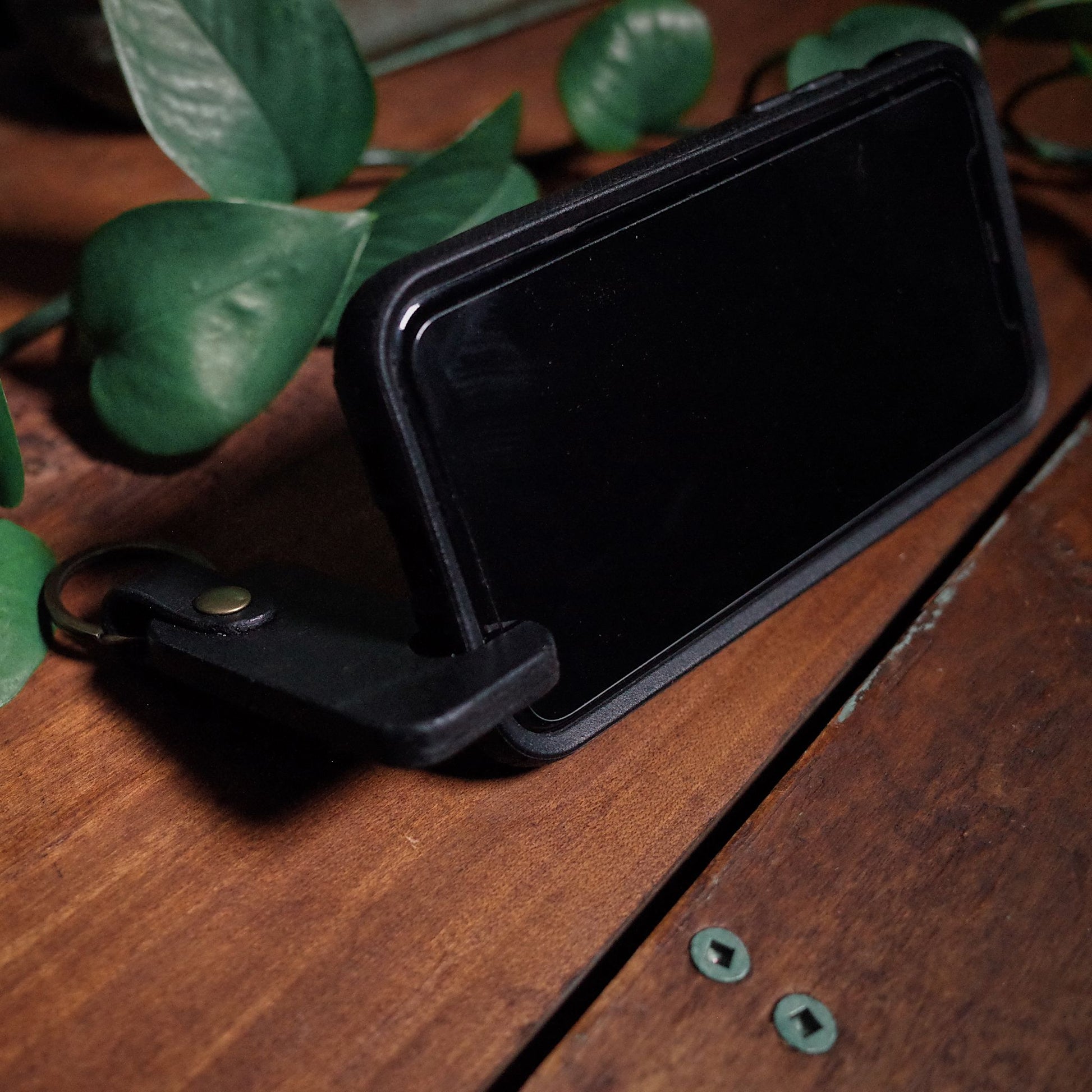 Premium black leather key holder with integrated phone holder
