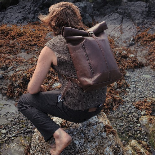 Spacious chocolate leather roll-top rucksack designed for everyday use
